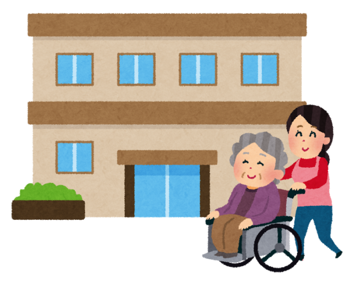施設の前に居る車椅子のおばあさんと女性